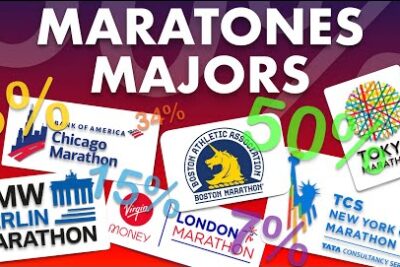 Corredores participando en un maratón en una ciudad española, rodeados de espectadores animando.